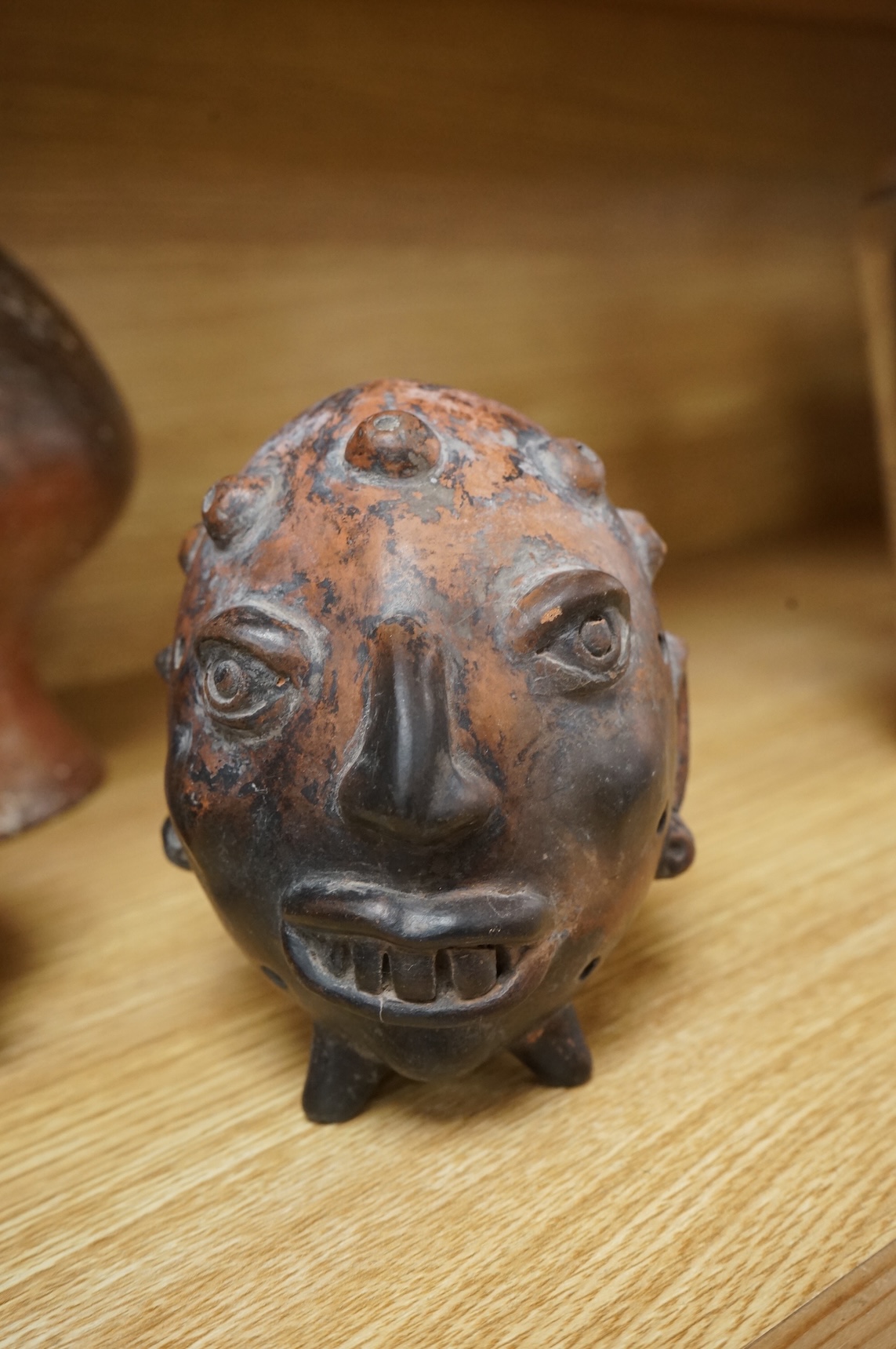 A collection of various South American vessels some in the form of grotesque heads, largest 24cm wide